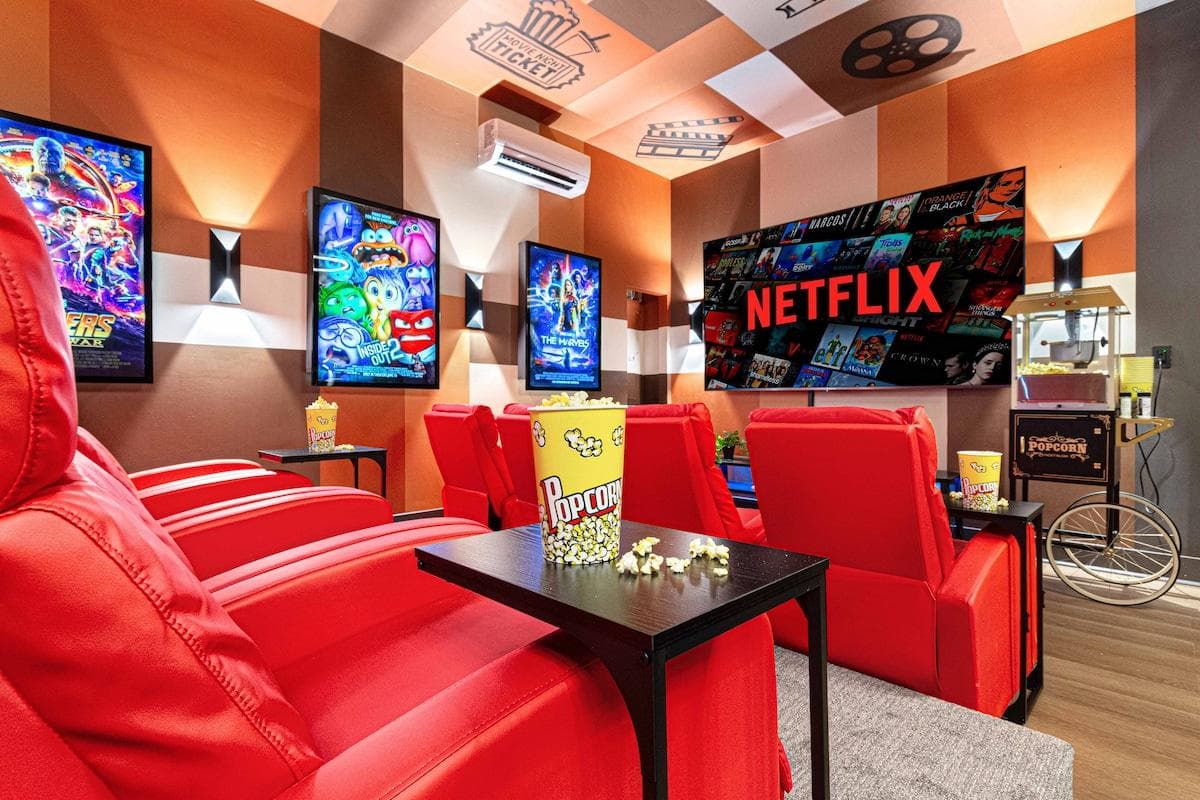 Movie nights feel extra special in this vibrant private theatre with reclining red chairs, a massive screen, custom ceiling art, and a nostalgic popcorn cart. Binge your favorites or screen a film—this is movie magic reimagined for all ages.