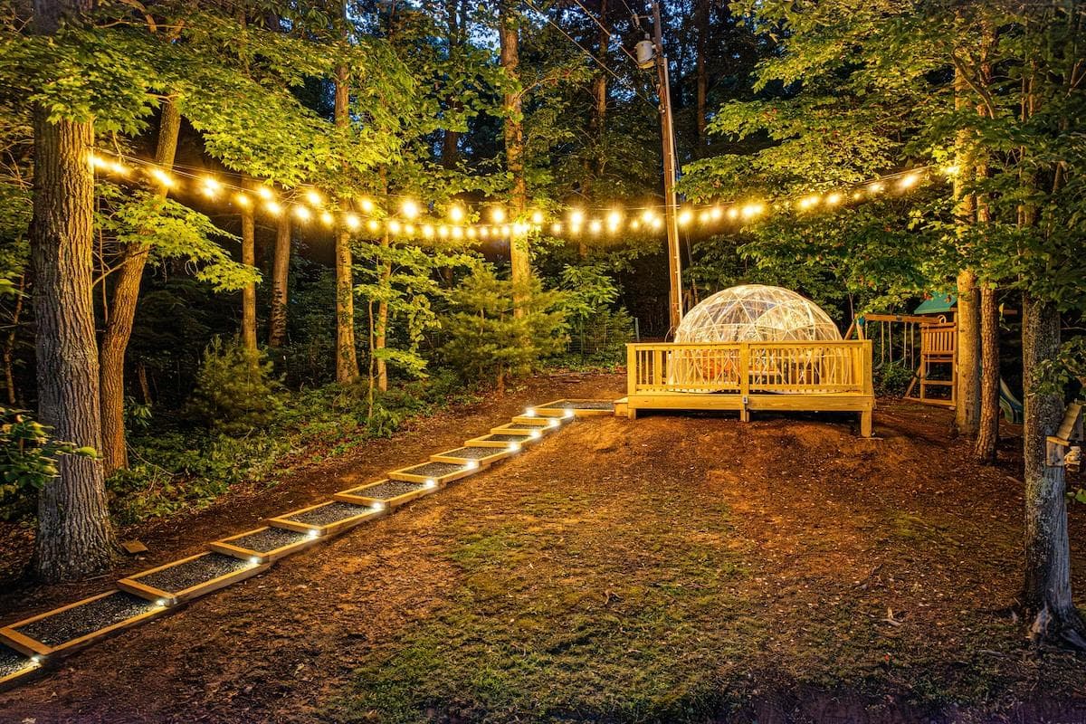 Our glowing geodome is a magical space to lounge, read, or stargaze under the forest canopy. String lights lead you to this peaceful, one-of-a-kind hangout spot where nature meets cozy glamping vibes, perfect for evening connection and calm.