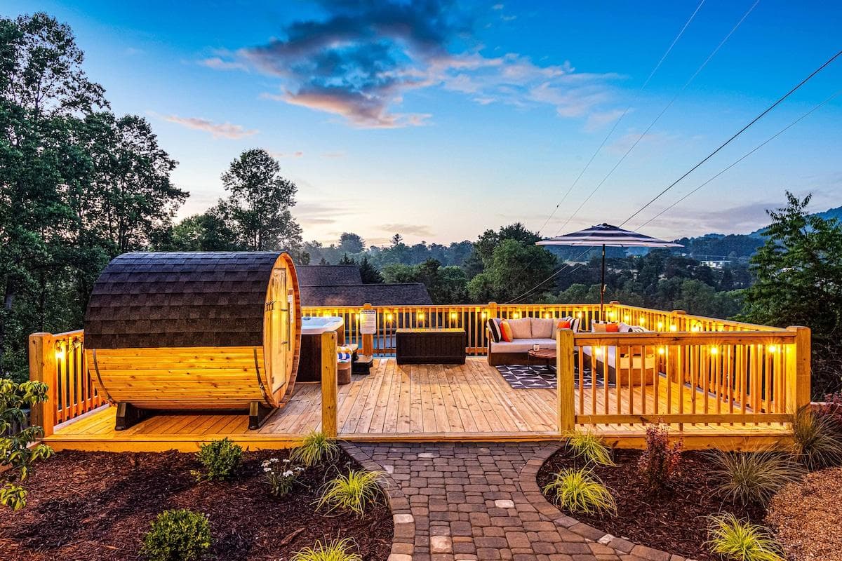 Soak in the mountain air and relax in your private outdoor wellness deck complete with a barrel sauna, hot tub, plush seating, and string lights. This is where sunset views meet spa-level calm, all just steps from your living room.